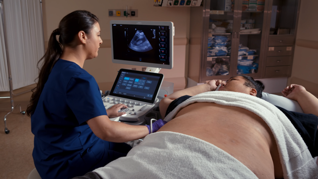 The Acuson Sequoia with Deep Abdominal Transducer (DAX) scanning a 600 pound patient.