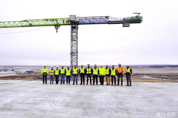 Shine executives are joined by the company’s construction managers and partners at its medical isotope production facility. The group was commemorating the facility’s achievement of weathertight status