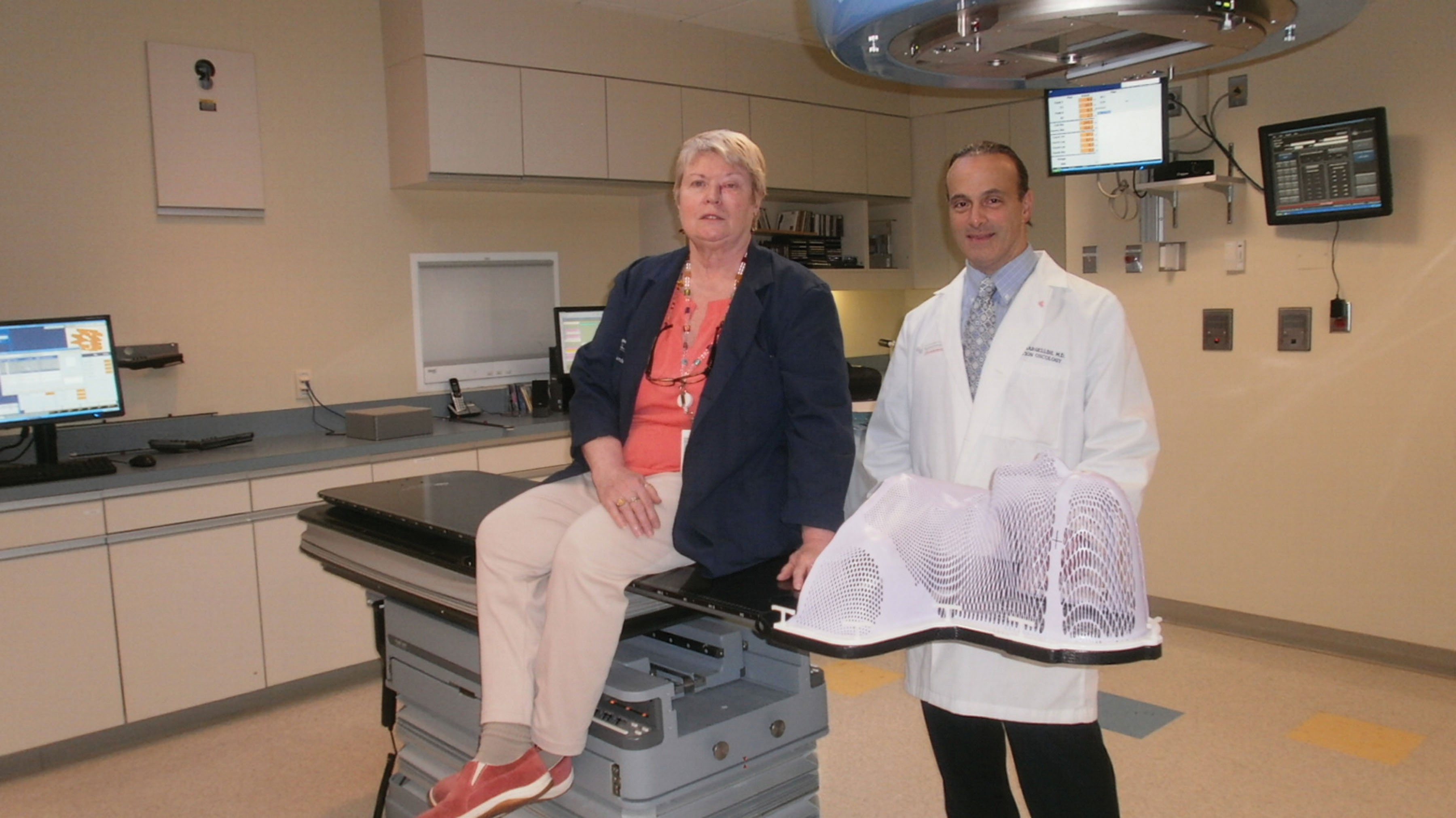 The high-level precision afforded by the Protura Robotic Patient Positioning System made all the difference in cancer treatment for patient Kathy Kelly, shown with her doctor, Joseph Bargellini.