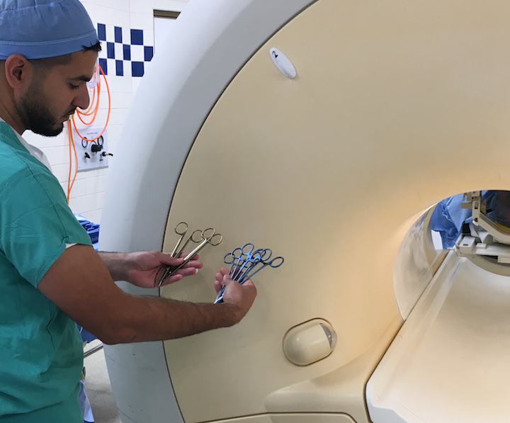 Staff at Henry Ford Hospital's neuro-MRI suite showing how the surgical instruments are all MRI safe.