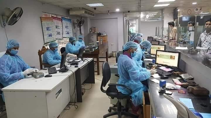 While it looks like the inside of a hospital, these are actually bank tellers in full personal protective equipment (PPE) in Bangladesh in early March 2020. There was widespread fear the virus would quickly spread across this poor country with limited healthcare resources, so many companies too precautions to protect their employees. Photo from Aster Azalea. 
