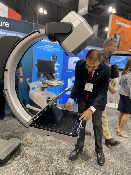 Rob Fabrizio, director of strategic marketing, medical imaging systems, Fujifilm Healthcare Americas Corporation, demonstrates the FDR Cross, Fujifilm’s newly developed hybrid C-arm and portable X-ray solution designed for intensive care, emergency room and intraoperative use, at #AHRA22. 