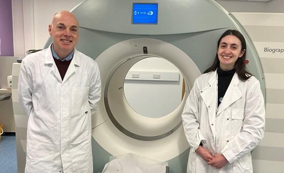 Prof Andy Sutherland and Dr Adriana Tavares in front of a patient scanner at QMRI, Edinburgh 
