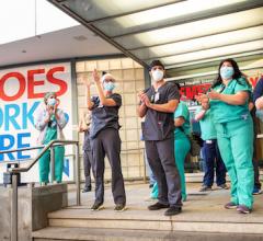 Signs for "Heroes work here" outside healthcare facilities and even the homes of clinicians have popped up across the country. This photo shows healthcare workers at the Lenox Health emergency room entrance being greeted to cheers and thanks for their essential service during the COVID-19 pandemic in New York City at a public thank you event May 21, 2020.