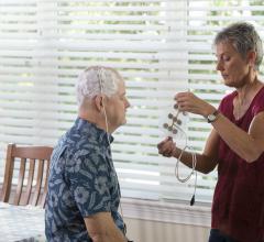 The patient’s wife changes the Optune array. Clinical trials indicate that the electrical fields emitted by Optune have the potential to lengthen the lives of patients with glioblastoma.