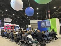 A common sight, just one of dozens of jam-packed sessions presented during RSNA 2022 in the AI Theater offering the latest technology and data to attendees.