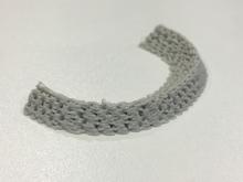 A 3-D printed meniscus made out of a flexible, biocompatible polymer and created based on a patient's CT scan of their knee. This can be implanted to replace the damage native meniscus and the bioprinted matrix allows for cellular growth. 