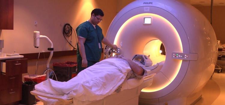 Figure 2. Technologist preparing patient for brain MRI.