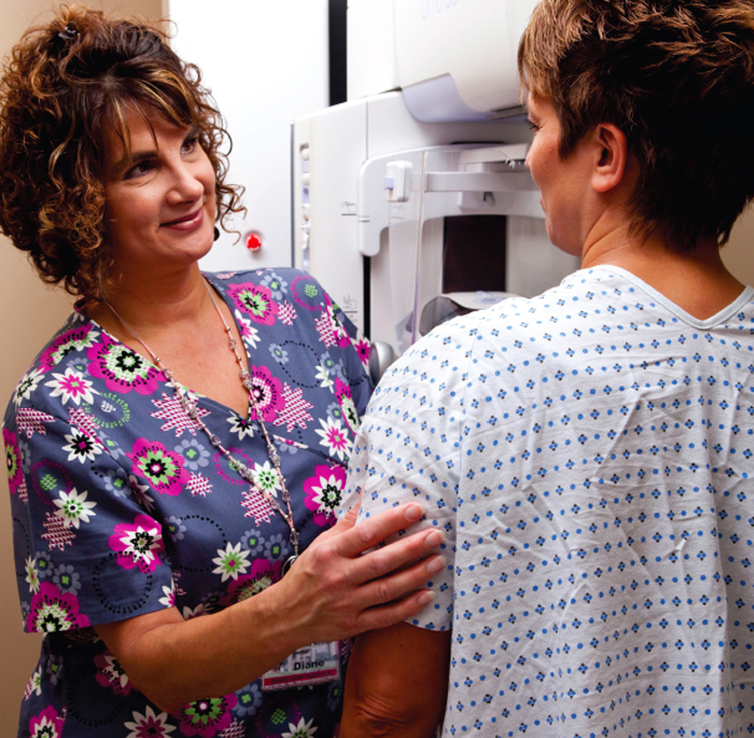 Diane Coady, R.T. (R)(M), breast center supervisor, talks to a patient about the 3D mammogram provided by Willamette Valley Medical Center.